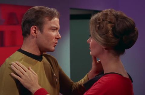 Captain Kirk and Dr. Mulhall  begin to embrace.